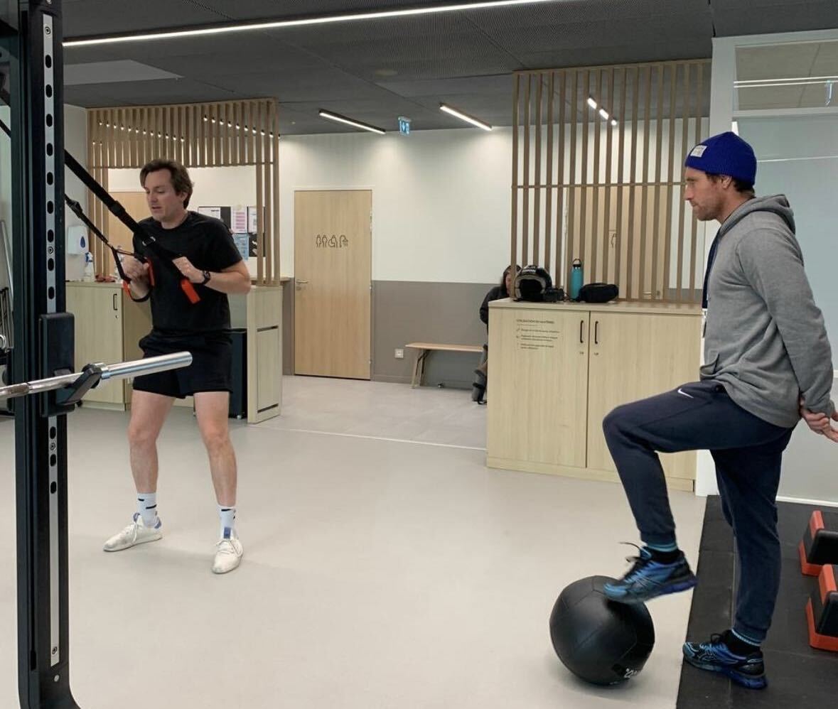 A coach guiding a client through a training session